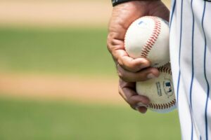 Man holding baseballs for IIBEC Central Texas Chapter's 2025 Golf Social.
